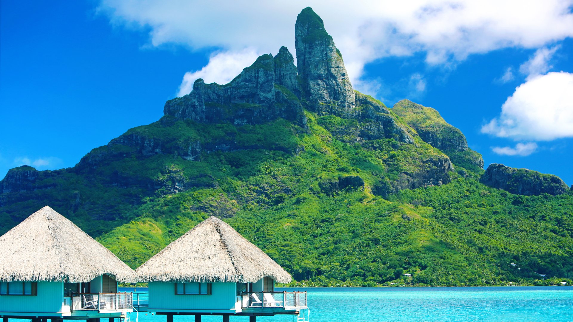 Mt. Otemanu in front of blue water and overwater bungalows in Bora Bora, French Polynesia